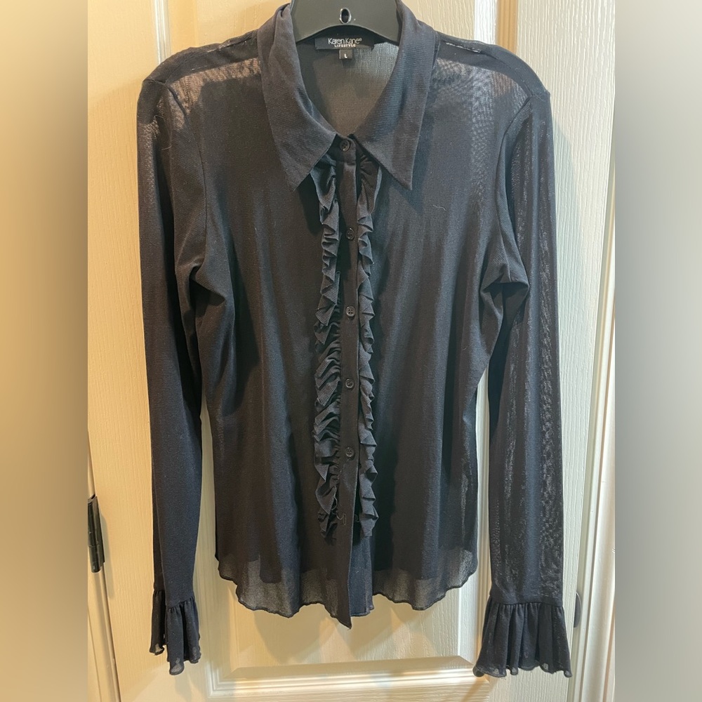 Sheer blouse with ruffles.
